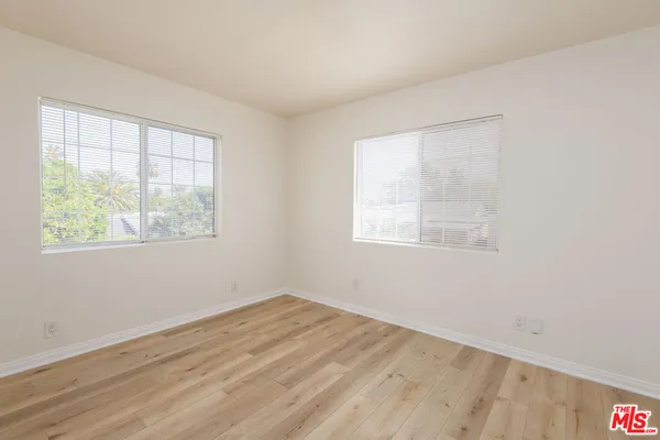 a view of a room with wooden floor and windows