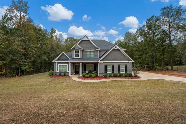 a front view of a house with a yard