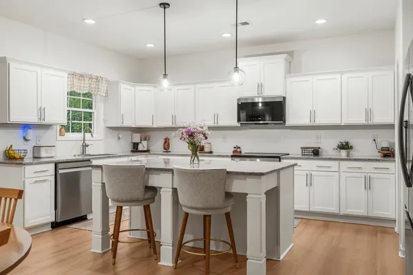 a kitchen with a sink cabinets and window