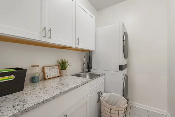 a bathroom with a granite countertop toilet and a sink