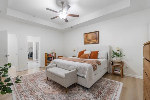 a spacious bedroom with a bed and a chandelier