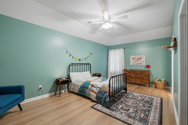 a bedroom with furniture and a window