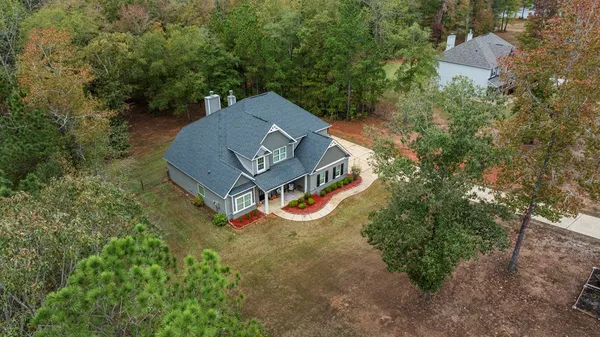 an aerial view of a house with outdoor space and street view