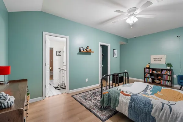 a bedroom with a bed and a chandelier