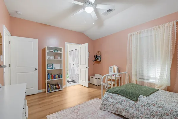 a living room with furniture and a book shelf