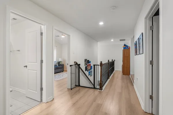 a view of a hallway with wooden floor