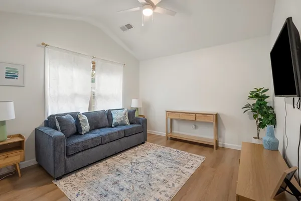 a living room with furniture and a flat screen tv