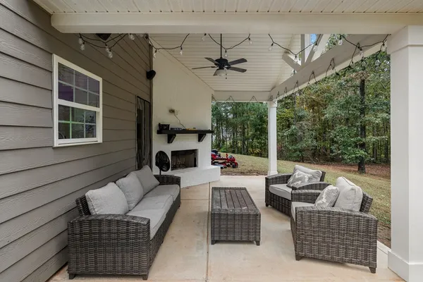 a balcony with furniture and a potted plant