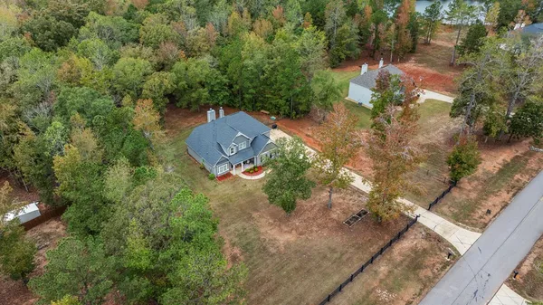 an aerial view of a house with a yard