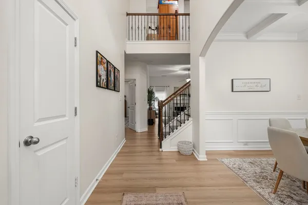 a hallway with wooden floor and windows