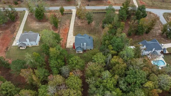 an aerial view of a house with a yard