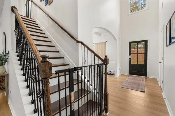 a view of staircase with railing and white walls