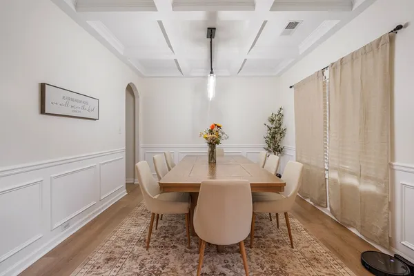 a view of a dining room with furniture and wooden floor