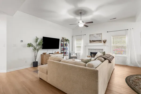 a living room with furniture a flat screen tv and a fireplace