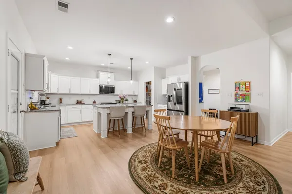 a large kitchen with a table and chairs