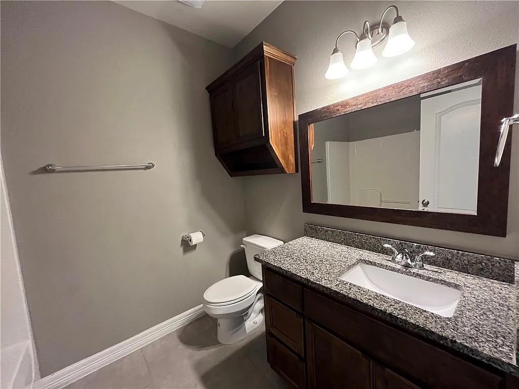 2229 Ruby Drive Corpus Christi, TX 78414 - Photo 3 of 5 a bathroom with a granite countertop toilet sink and mirror