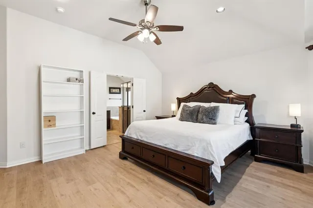 a spacious bedroom with a bed and a chandelier