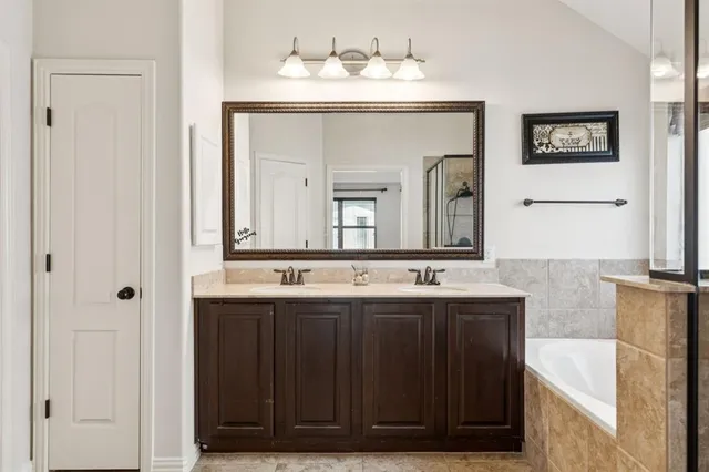 a bathroom with a double vanity sink and a mirror