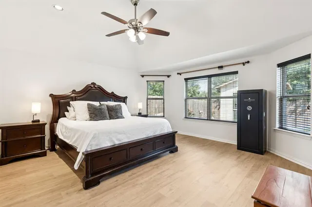 a spacious bedroom with a bed and a window