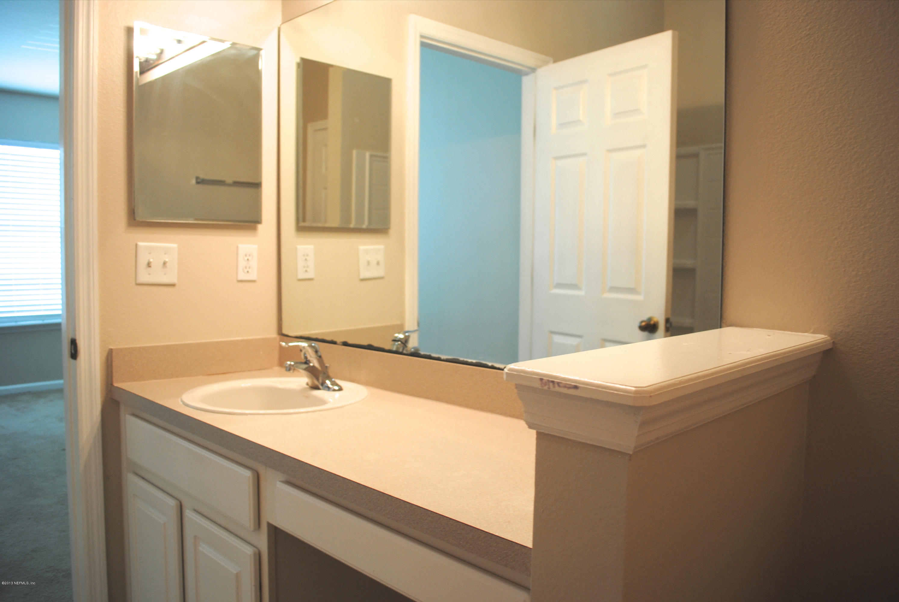 584 Crystal Way Orange Park, FL 32065 - Photo 16 of 22 a bathroom with a sink and a mirror