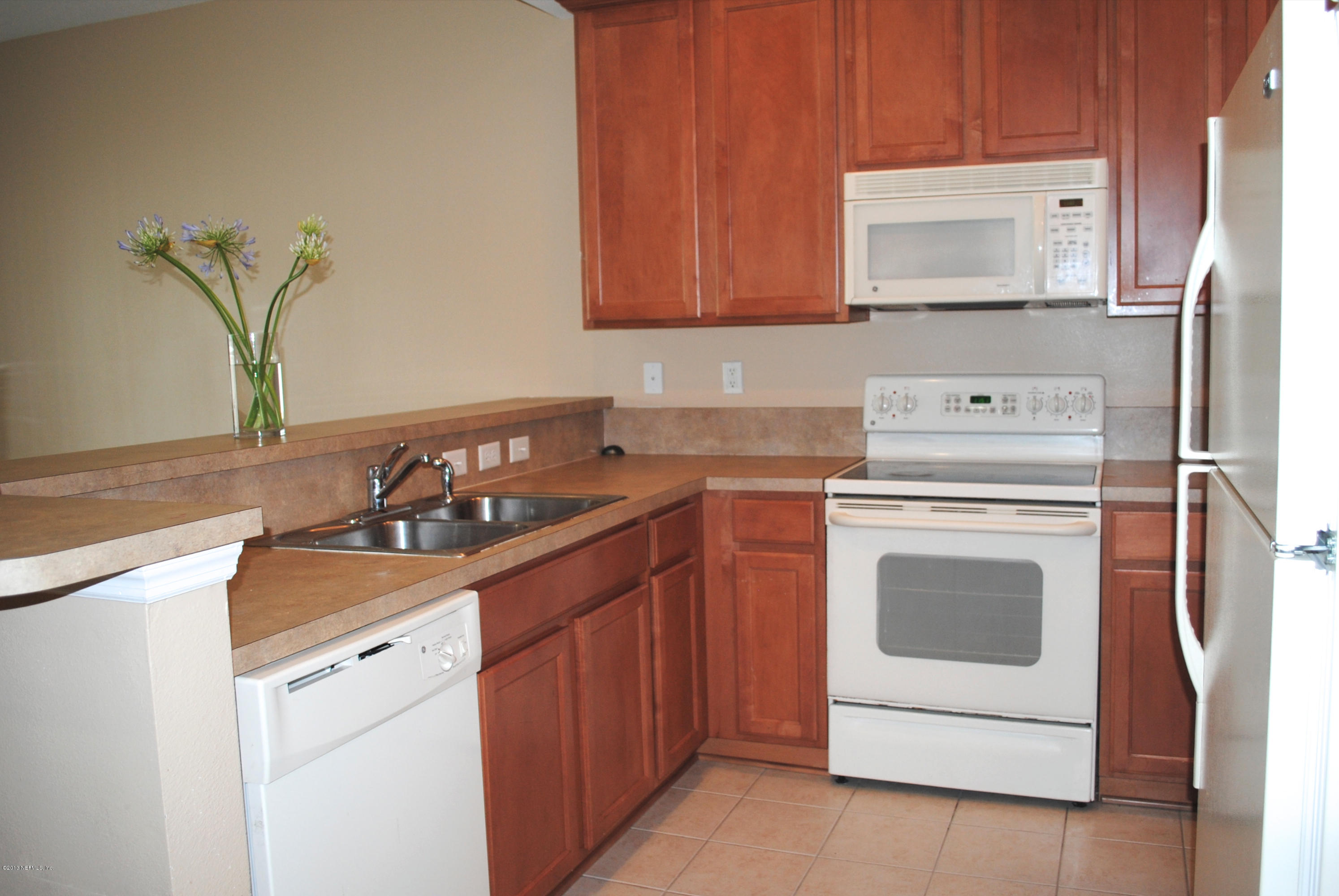 584 Crystal Way Orange Park, FL 32065 - Photo 3 of 22 a kitchen with a sink stove and microwave