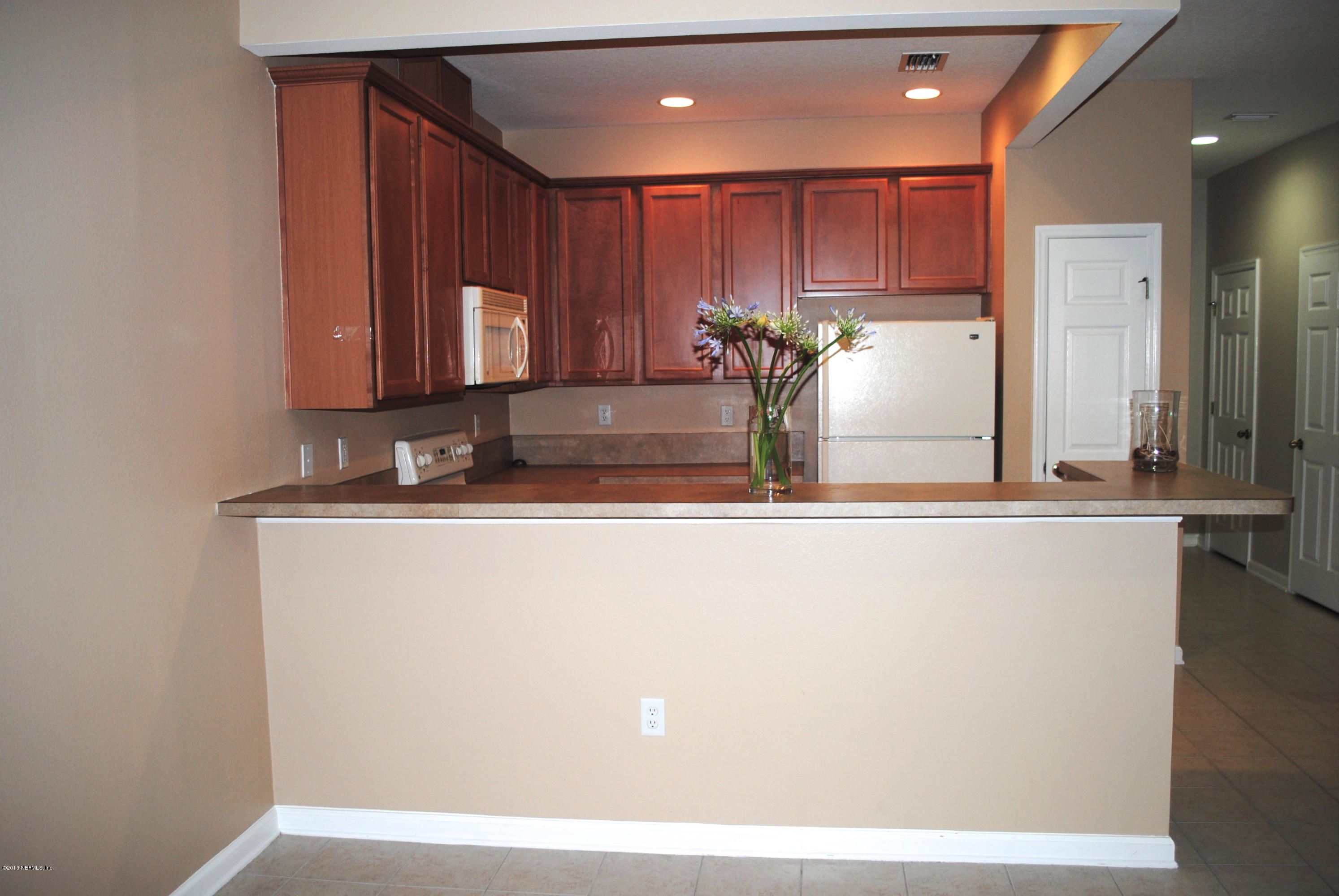 584 Crystal Way Orange Park, FL 32065 - Photo 8 of 22 a view of kitchen with stainless steel appliances granite countertop refrigerator sink and cabinets