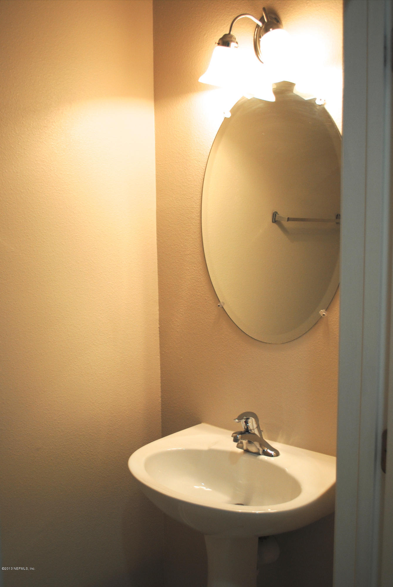 584 Crystal Way Orange Park, FL 32065 - Photo 9 of 22 a bathroom with a sink and a mirror