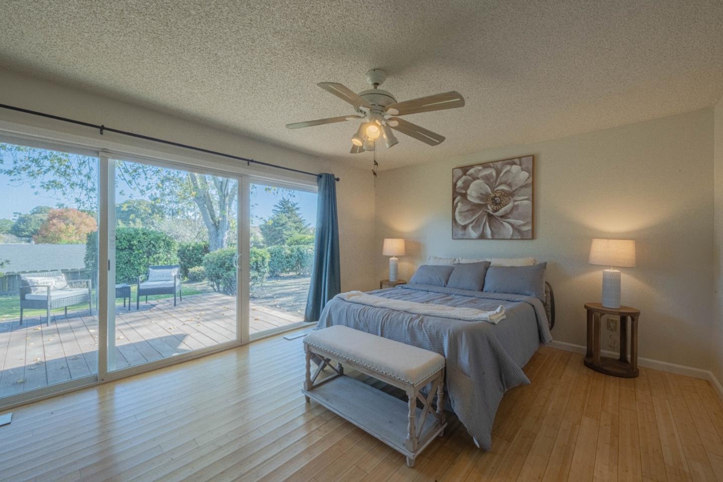9919 Mimosa Path Salinas, CA 93907 - Photo 16 of 39 a bedroom with a large bed and a chandelier