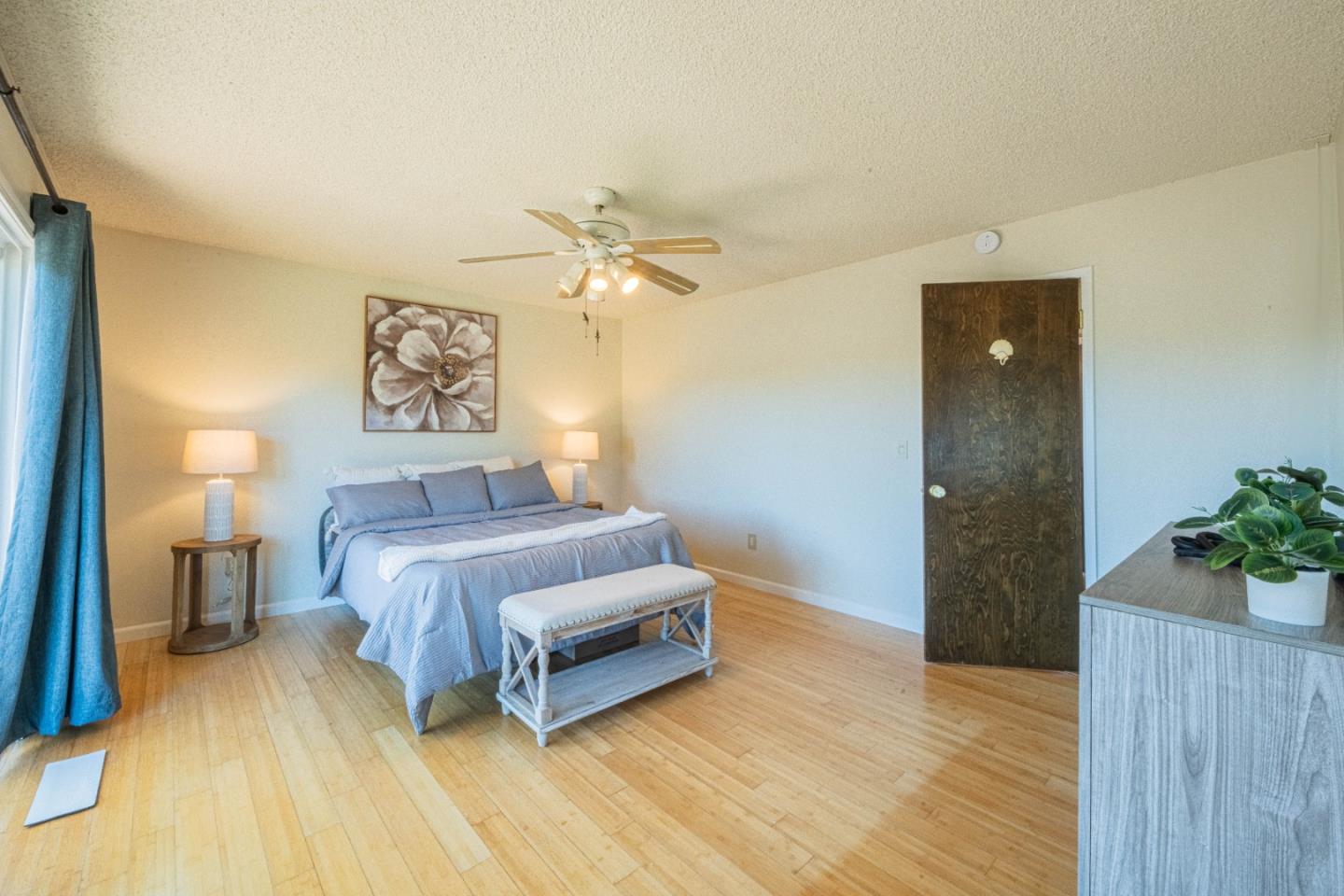 9919 Mimosa Path Salinas, CA 93907 - Photo 21 of 39 a bedroom with a bed and a chandelier