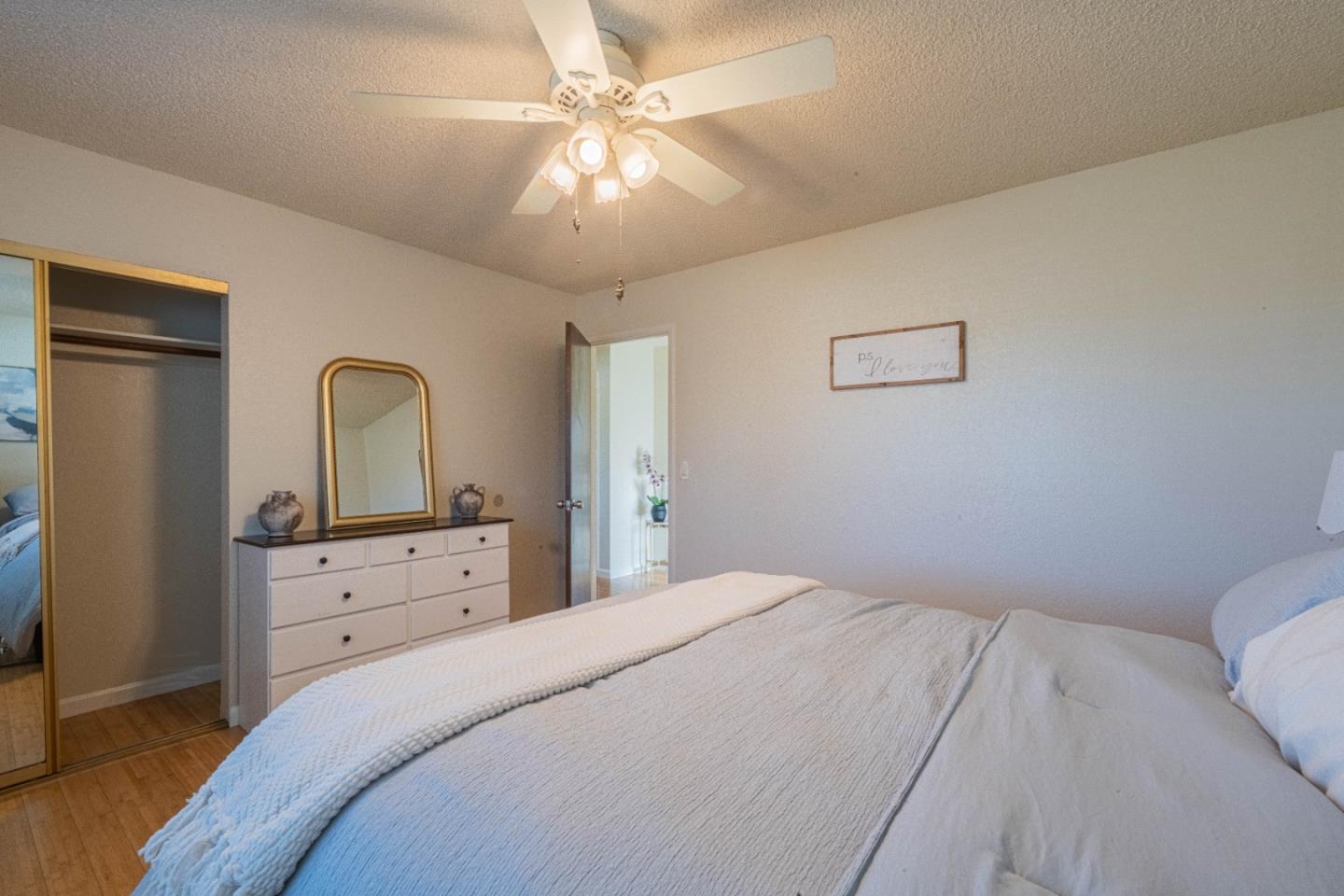9919 Mimosa Path Salinas, CA 93907 - Photo 27 of 39 a bedroom with a bed and a chandelier