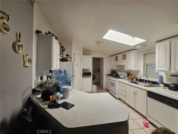 a kitchen with a sink a stove and chairs