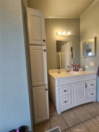 a bedroom with furniture and a flat screen tv