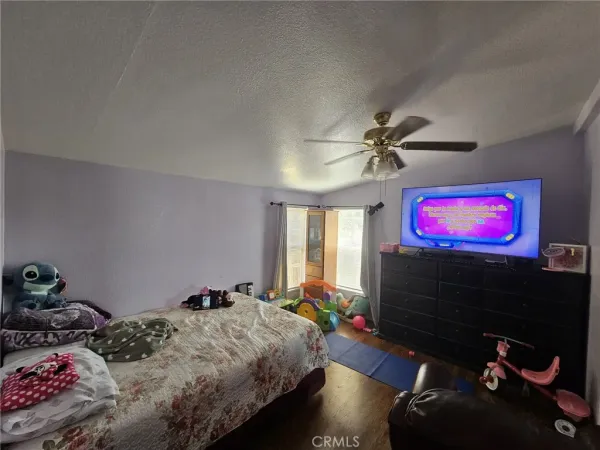 a bedroom with furniture and a flat screen tv