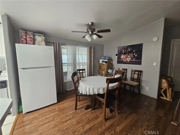 a view of a dining room with furniture wooden floor and a chandelier