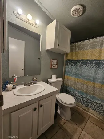a bathroom with a sink toilet and a mirror