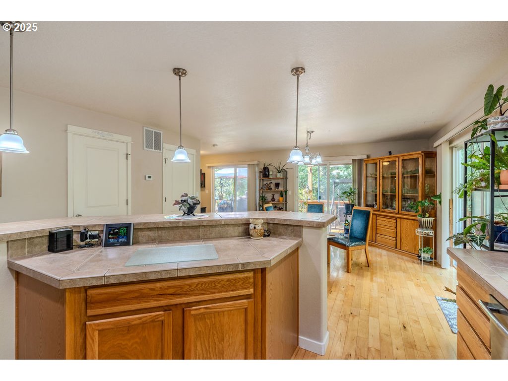 37702 Hamilton Ridge Drive Sandy, OR 97055 - Photo 15 of 44 a kitchen with a sink cabinets and dining table