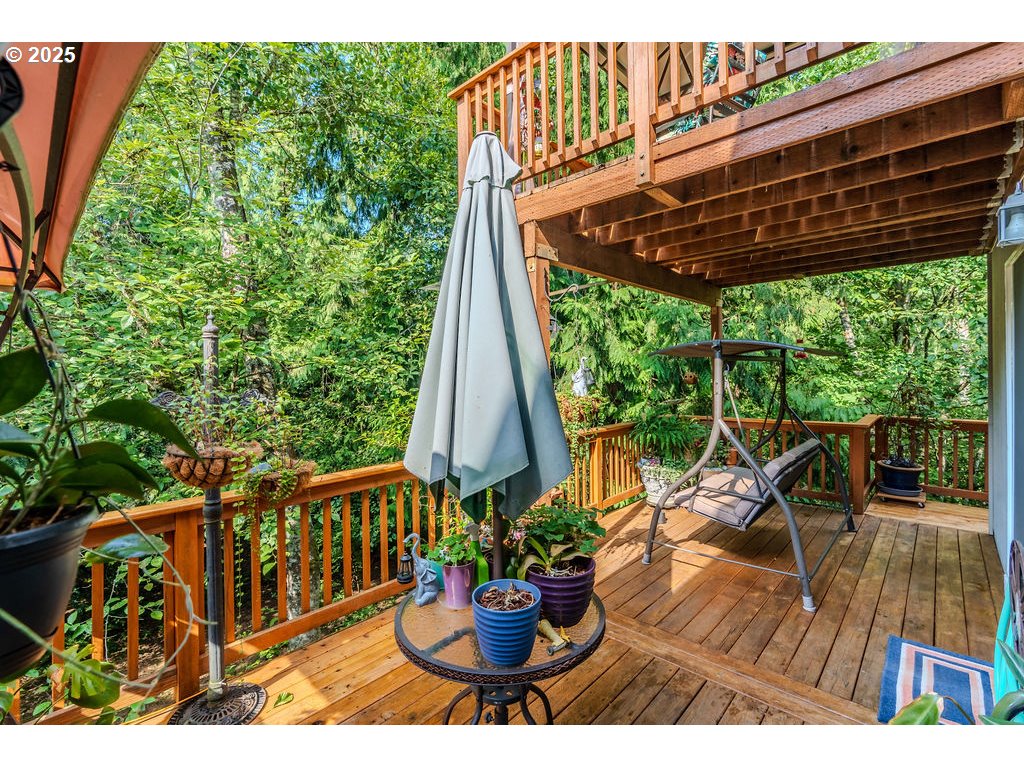 37702 Hamilton Ridge Drive Sandy, OR 97055 - Photo 20 of 44 a view of a patio with table and chairs potted plants with wooden floor