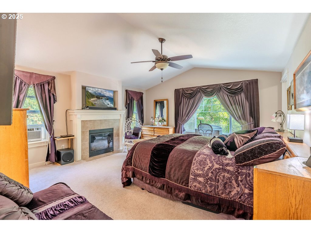 37702 Hamilton Ridge Drive Sandy, OR 97055 - Photo 24 of 44 a bed room with a bed and a fireplace