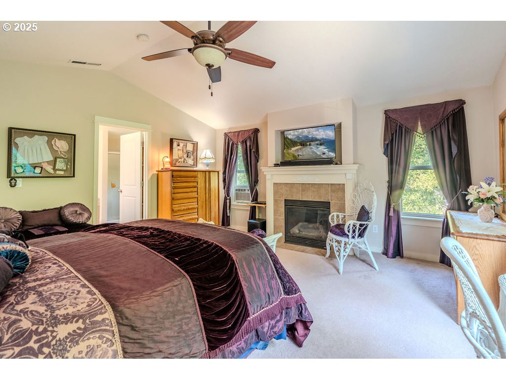 37702 Hamilton Ridge Drive Sandy, OR 97055 - Photo 26 of 44 a bed room with a bed and a fireplace
