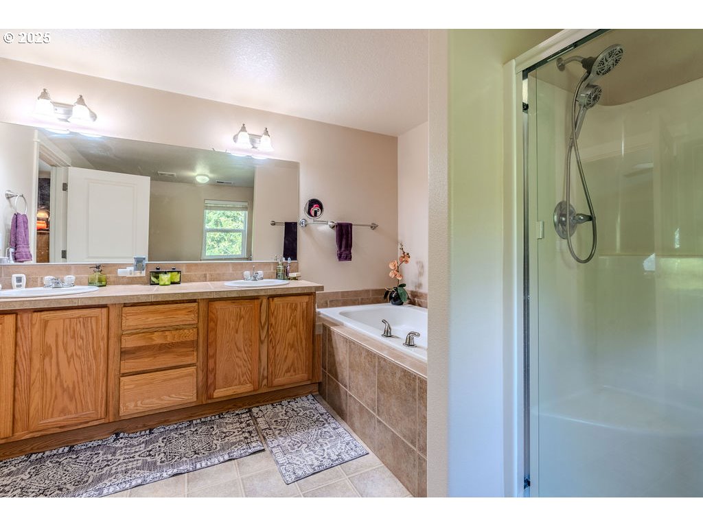 37702 Hamilton Ridge Drive Sandy, OR 97055 - Photo 27 of 44 a bathroom with a granite countertop sink mirror and a bathtub