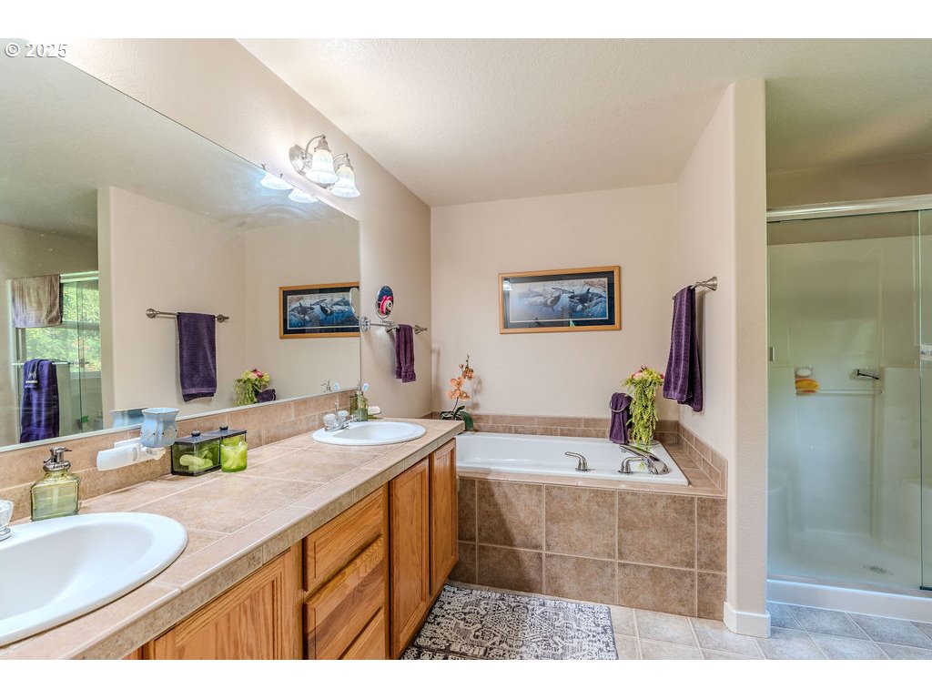 37702 Hamilton Ridge Drive Sandy, OR 97055 - Photo 28 of 44 a bathroom with a sink double vanity granite tub shower and a mirror