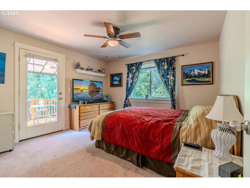 37702 Hamilton Ridge Drive Sandy, OR 97055 - Photo 30 of 44 a bed room with a bed and a large window
