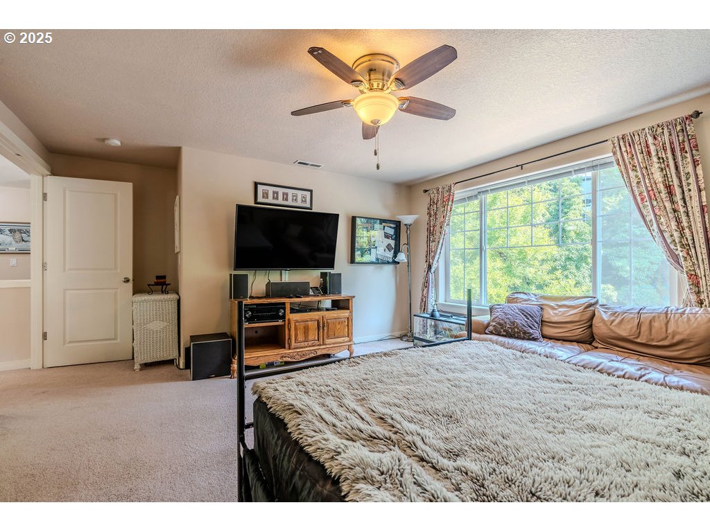 37702 Hamilton Ridge Drive Sandy, OR 97055 - Photo 35 of 44 a bedroom with a bed and a flat screen tv