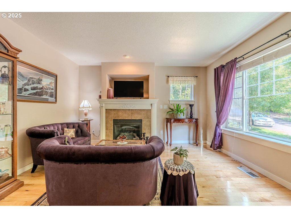 37702 Hamilton Ridge Drive Sandy, OR 97055 - Photo 9 of 44 a living room with furniture and a fireplace
