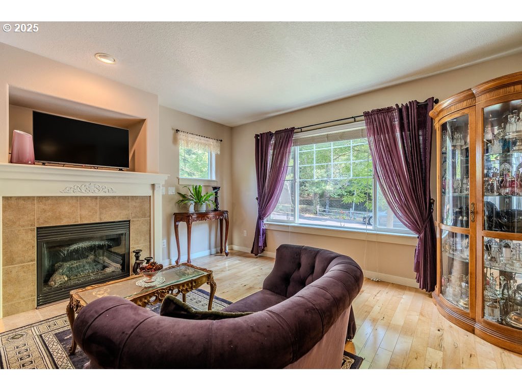 37702 Hamilton Ridge Drive Sandy, OR 97055 - Photo 10 of 44 a living room with furniture a fireplace and a flat screen tv