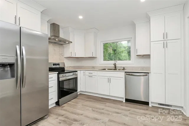 a kitchen with a refrigerator and a sink
