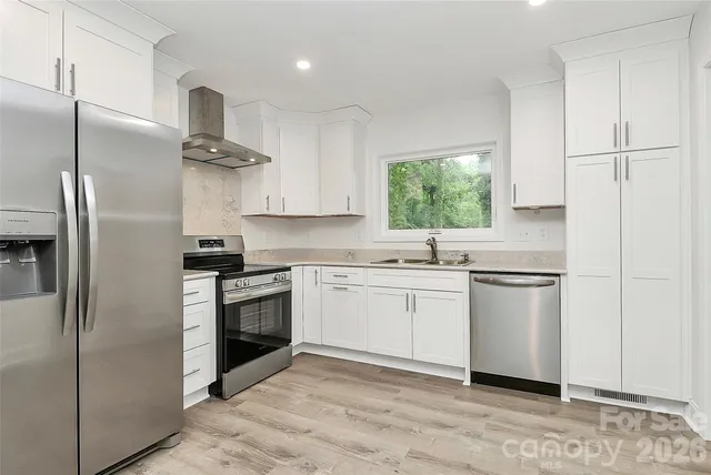 a kitchen with a refrigerator and a sink