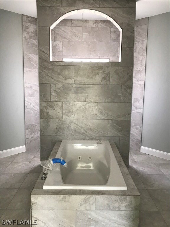3403 35th Street Southwest Lehigh Acres, FL 33976 - Photo 5 of 7 a bath tub sitting in a bathroom