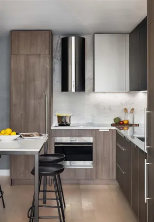 a kitchen with stainless steel appliances a stove refrigerator sink and cabinets
