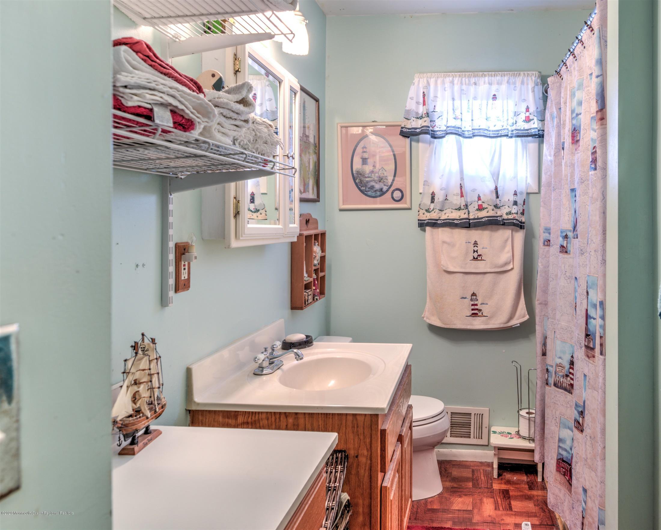 60 Mallard Road Bayville, NJ 08721 - Photo 13 of 20 a bathroom with a sink a vanity and a mirror